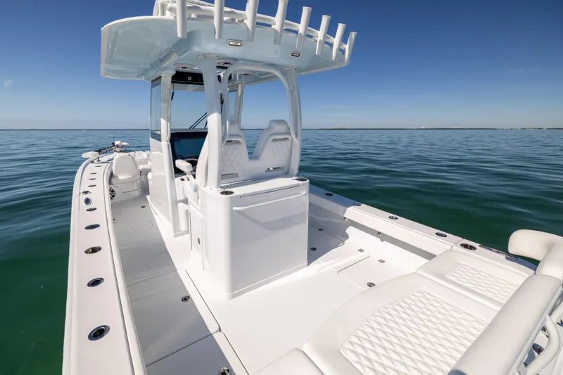 Slide: The Image of Freeman 28 boat, 2025 model, on calm ocean waters under clear blue sky. - 22