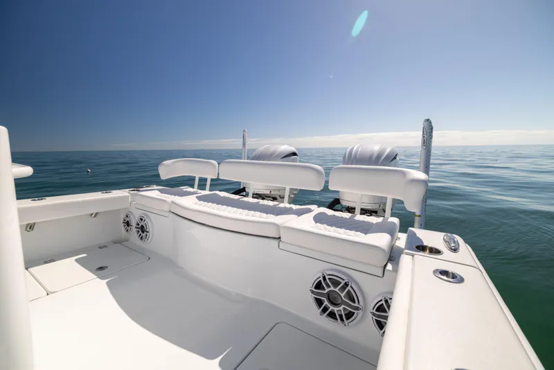 Slide: The Image of Freeman 28 boat, 2025 model, with spacious seating on open water under clear sky. - 27
