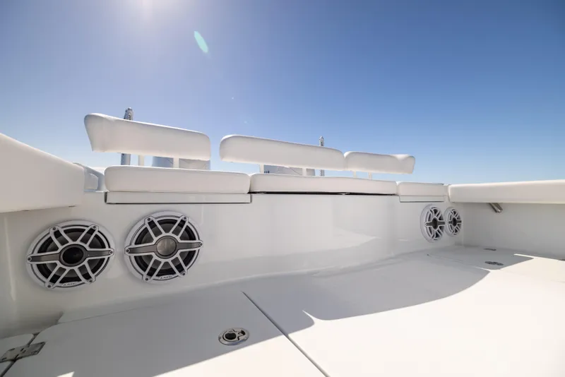 Slide: The Image of Freeman 28 boat deck with speakers, 2025 model, under clear blue sky. - 29