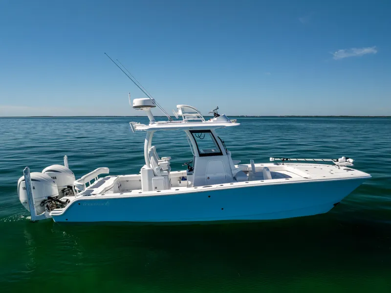 Slide: The Image of Freeman 28 boat, 2025 model, floating on calm blue water under clear sky. - 3