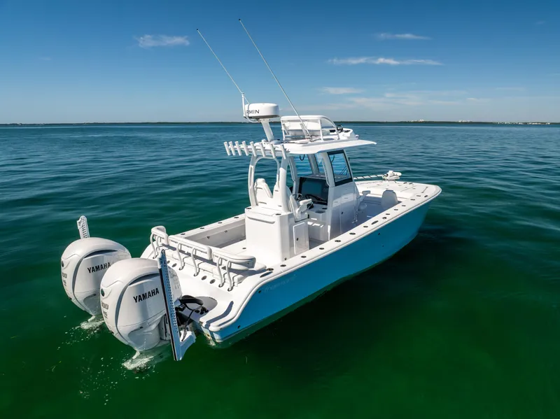 Slide: The Image of 2025 Freeman 28 boat with twin Yamaha engines on clear blue water. - 4