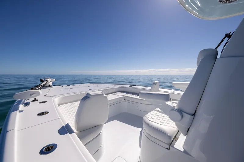Slide: The Image of 2025 Freeman 28 boat interior with white seating on open water. - 42