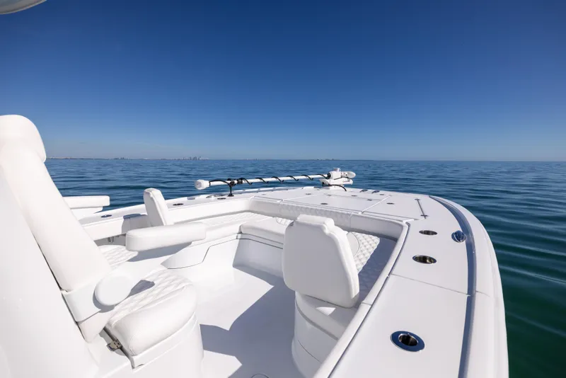 Slide: The Image of Freeman 28 boat, 2025 model, with white seating on calm ocean waters under clear blue sky. - 43