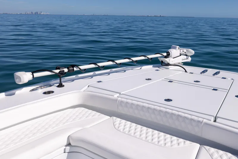 Slide: The Image of Freeman 28 boat deck, 2025 model, on calm ocean waters under clear blue sky. - 44