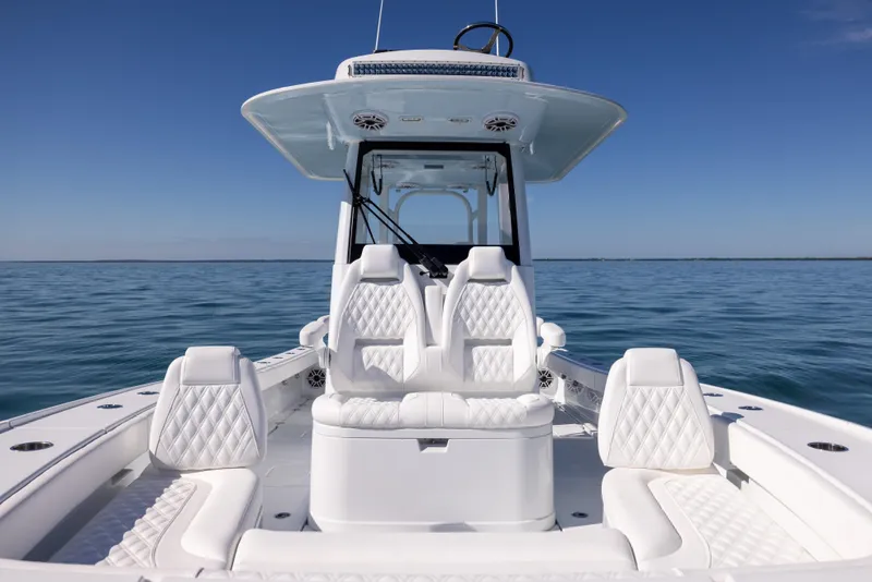 Slide: The Image of 2025 Freeman 28 boat with luxurious white seating on calm ocean waters. - 46