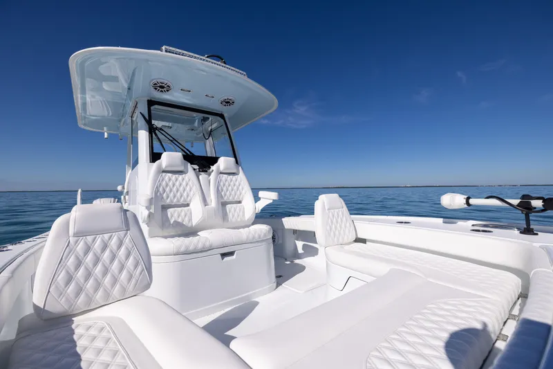 Slide: The Image of 2025 Freeman 28 boat with luxurious white seating on a calm ocean. - 47