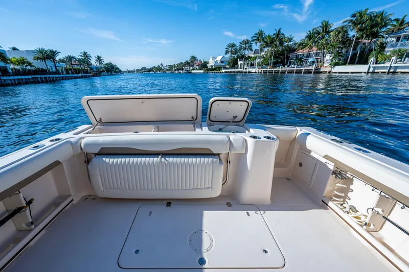 Slide: The Image of 2013 Grady-White 335 boat deck overlooking serene waterfront with palm trees. - 11
