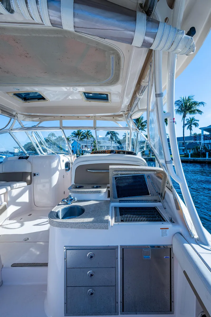 Slide: The Image of 2013 Grady-White 335 boat interior with sleek design, featuring a modern helm and waterfront view. - 13