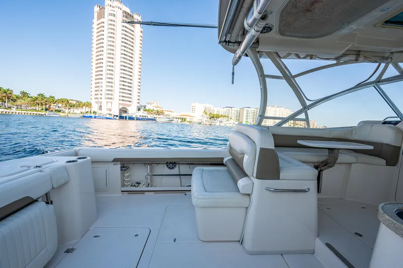 Slide: The Image of 2013 Grady-White 335 boat interior with waterfront cityscape in the background. - 14