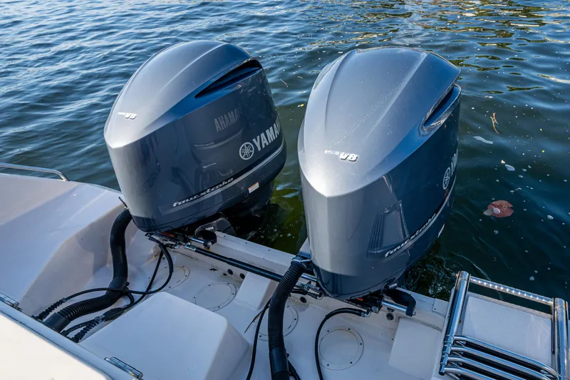 Slide: The Image of Twin Yamaha outboard engines on a 2013 Grady-White 335 boat, docked in water. - 15