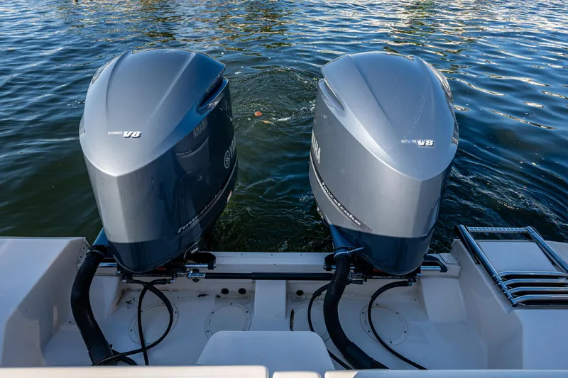 Slide: The Image of Twin outboard engines on a 2013 Grady-White 335 boat, floating on water. - 16