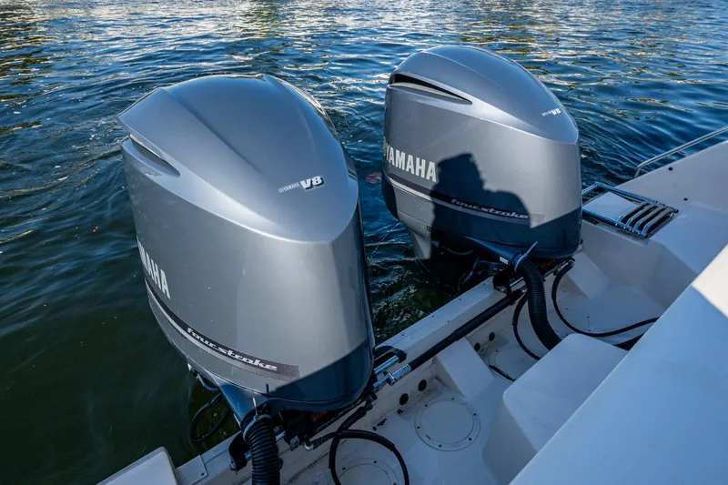 Slide: The Image of Twin Yamaha outboard engines on a 2013 Grady-White 335 boat, floating on water. - 17