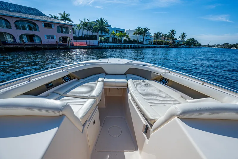 Slide: The Image of 2013 Grady-White 335 boat interior with waterfront view and luxurious seating. - 2