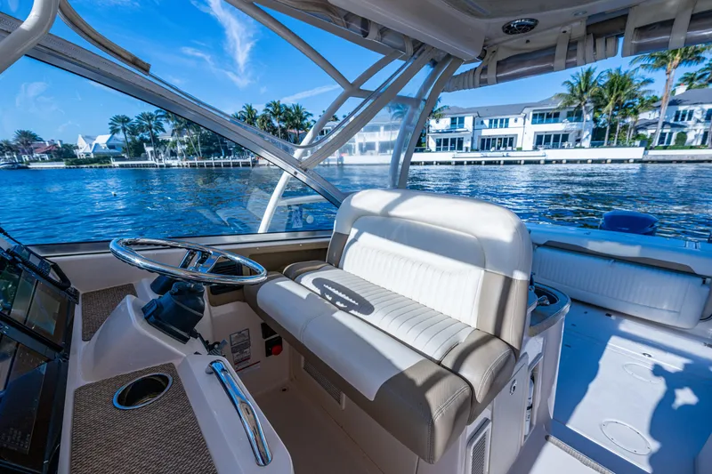Slide: The Image of 2013 Grady-White 335 boat interior with helm, seating, and waterfront view. - 20