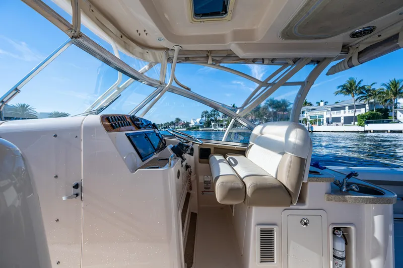 Slide: The Image of Interior view of 2013 Grady-White 335 boat cockpit with modern controls and seating. - 21