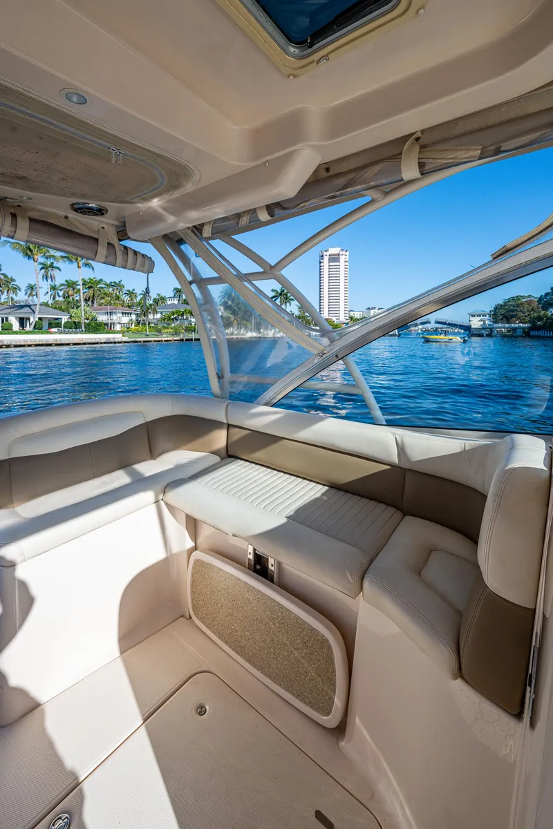 Slide: The Image of 2013 Grady-White 335 boat interior with seating, overlooking a scenic waterfront. - 22