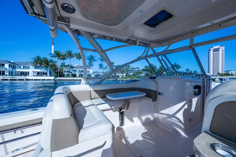 Slide: The Image of 2013 Grady-White 335 boat interior with waterfront view and modern seating. - 24
