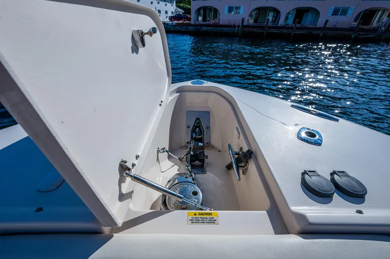 Slide: The Image of 2013 Grady-White 335 boat anchor compartment with open hatch, dockside view. - 3