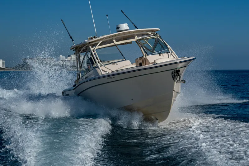 Slide: The Image of 2013 Grady-White 335 boat cruising swiftly on open water. - 41