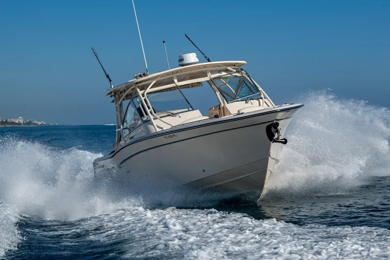 Slide: The Image of 2013 Grady-White 335 boat cruising through ocean waves on a sunny day. - 42