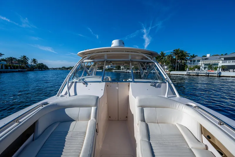 Slide: The Image of 2013 Grady-White 335 boat on a sunny day, cruising through a scenic waterway. - 5