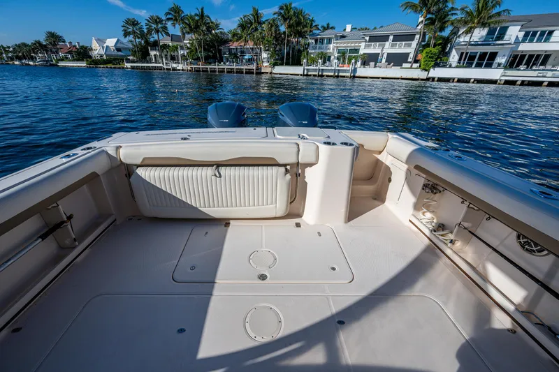 Slide: The Image of 2013 Grady-White 335 boat deck with waterfront view and palm trees. - 9