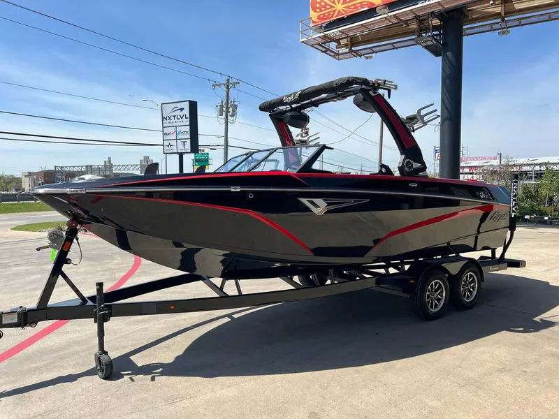 Slide: The Image of 2024 Tigé Z3 boat on trailer, black with red accents, parked outdoors. - 10