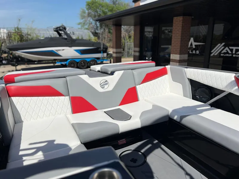 Slide: The Image of 2024 Tigé Z3 boat interior with red and gray seating, showcasing modern design. - 13