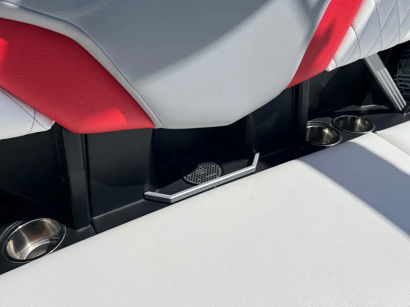Slide: The Image of 2024 Tigé Z3 boat interior with red and white upholstery, cup holders, and speaker. - 18