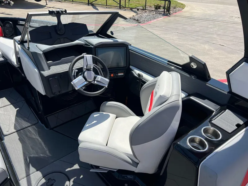 Slide: The Image of 2024 Tigé Z3 boat interior with modern steering wheel and comfortable seating. - 19