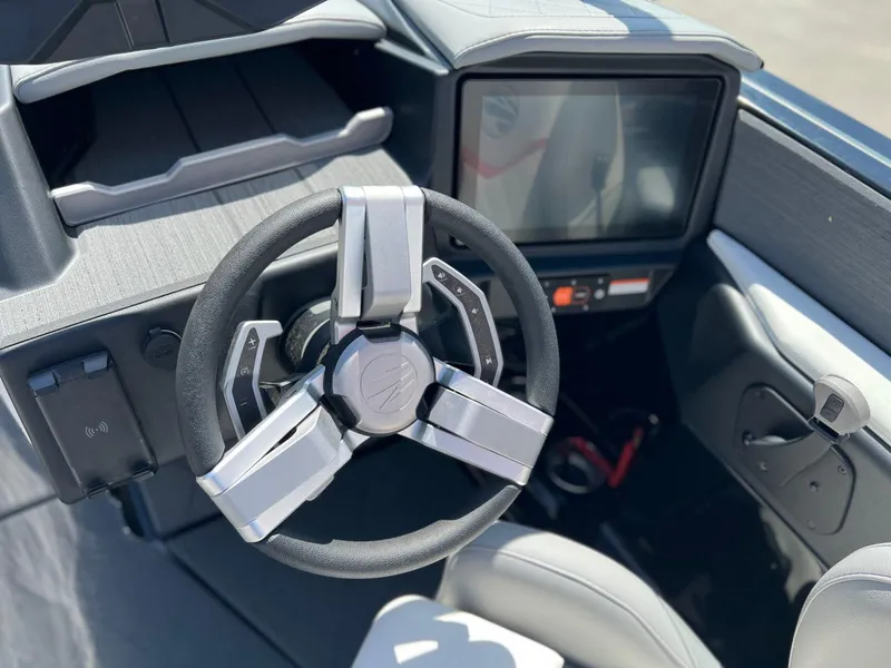 Slide: The Image of 2024 Tigé Z3 boat cockpit with modern steering wheel and touchscreen display. - 20