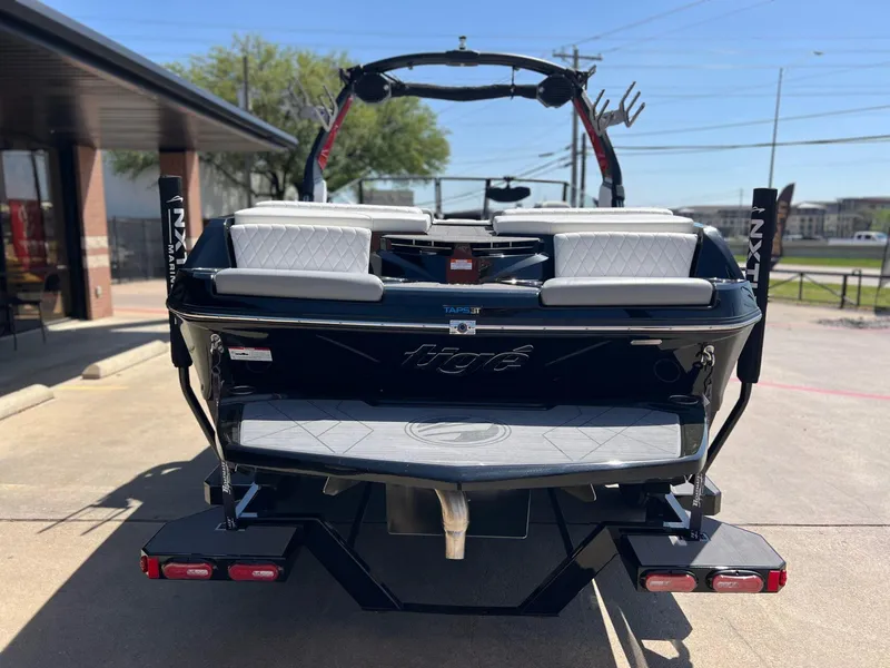 Slide: The Image of 2024 Tigé Z3 boat rear view with sleek design and dual seating. - 4