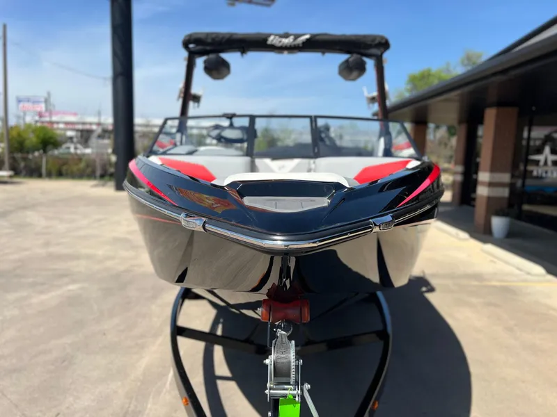 Slide: The Image of 2024 Tigé Z3 boat on trailer, front view, sleek design, red and black accents. - 7