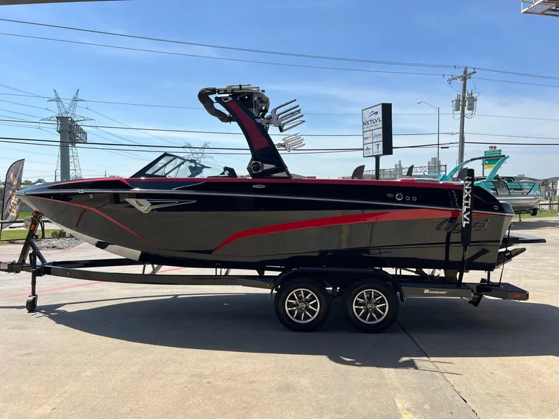 Slide: The Image of 2024 Tigé Z3 boat on trailer, black with red accents, parked outdoors. - 9
