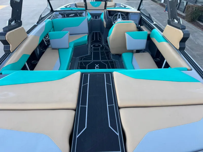 Slide: The Image of 2023 ATX Surf Boats 20 Type-S interior with teal and beige seating. - 11
