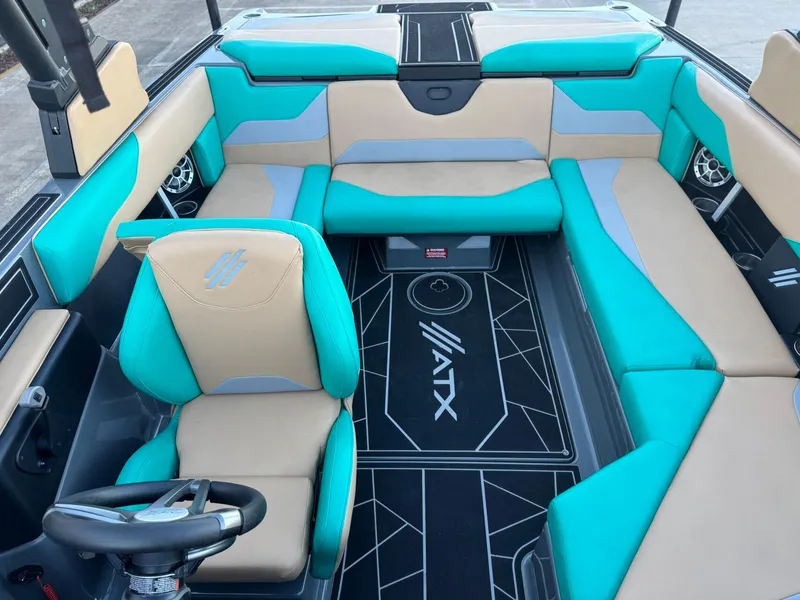 Slide: The Image of 2023 ATX Surf Boats 20 Type-S interior with teal and beige seating. - 13