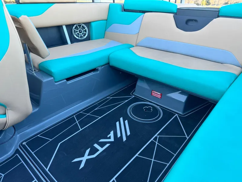 Slide: The Image of 2023 ATX Surf Boats 20 Type-S interior with teal and beige seating, stylish flooring. - 16