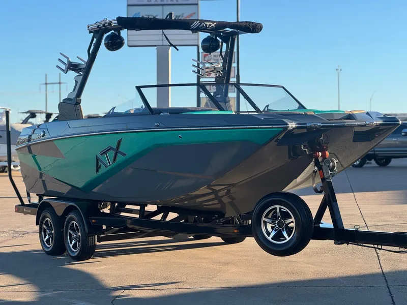 Slide: The Image of 2023 ATX Surf Boats 20 Type-S on trailer, sleek design, vibrant teal and black color scheme. - 4