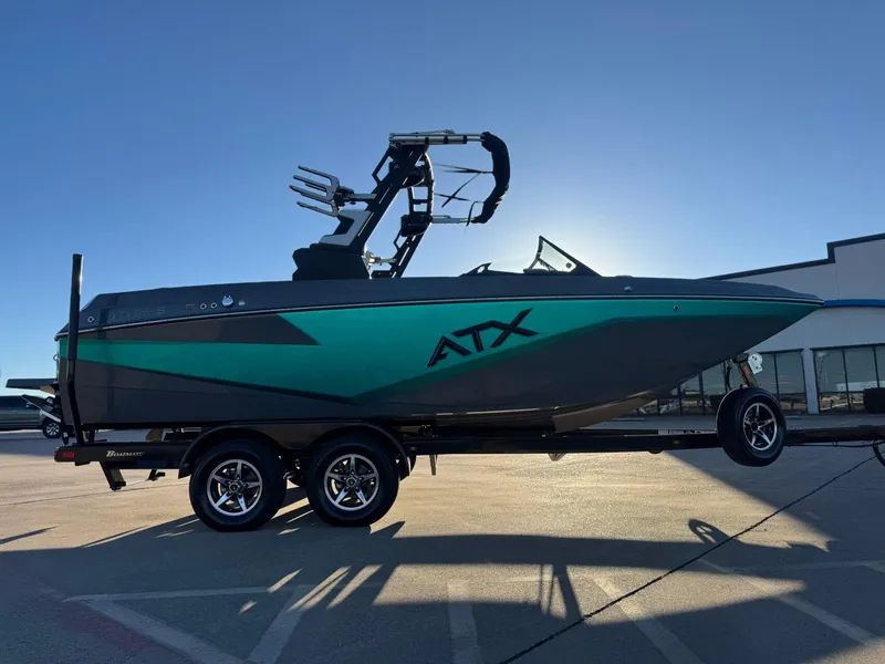 Slide: The Image of 2023 ATX Surf Boats 20 Type-S on trailer, teal and black design, sunny day. - 5