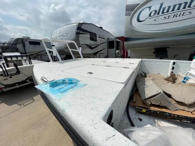 Slide: The Image of 2023 Freedom PATRIOT boat deck with RVs in the background, under a cloudy sky. - 10