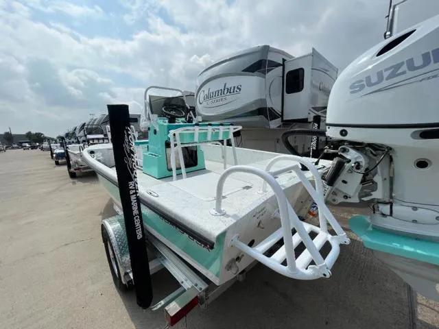 Slide: The Image of 2023 Freedom PATRIOT boat with Suzuki engine, parked near RVs under cloudy sky. - 4