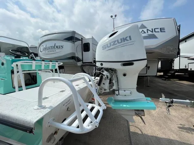 Slide: The Image of 2023 Freedom PATRIOT boat with Suzuki outboard motor, parked near RVs. - 5
