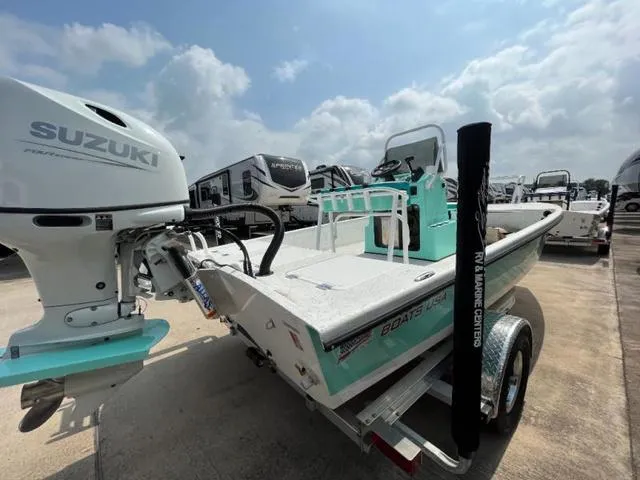 Slide: The Image of 2023 Freedom PATRIOT boat with Suzuki outboard motor, parked on a trailer under a cloudy sky. - 6