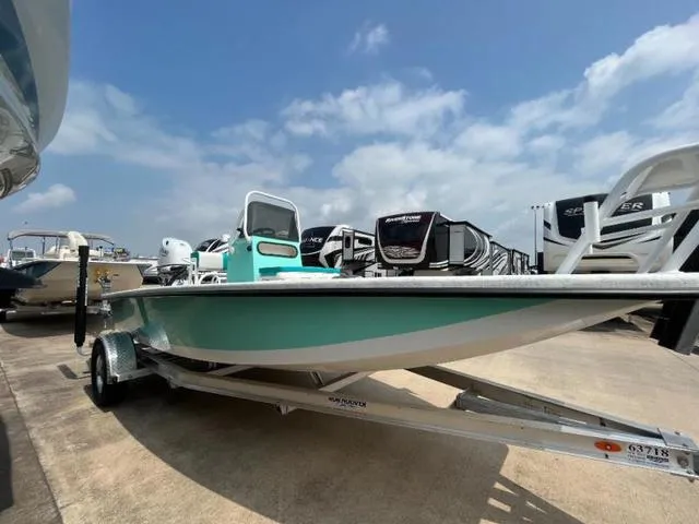 Slide: The Image of 2023 Freedom PATRIOT boat on trailer under blue sky. - 7