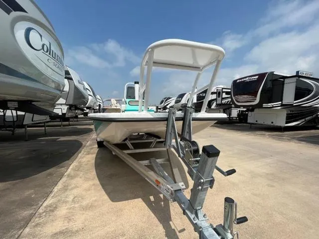 Slide: The Image of 2023 Freedom PATRIOT boat on trailer, parked among RVs under a clear blue sky. - 8