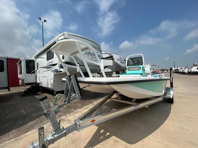 Slide: The Image of 2023 Freedom PATRIOT boat on trailer, parked near RVs under a clear blue sky. - 9