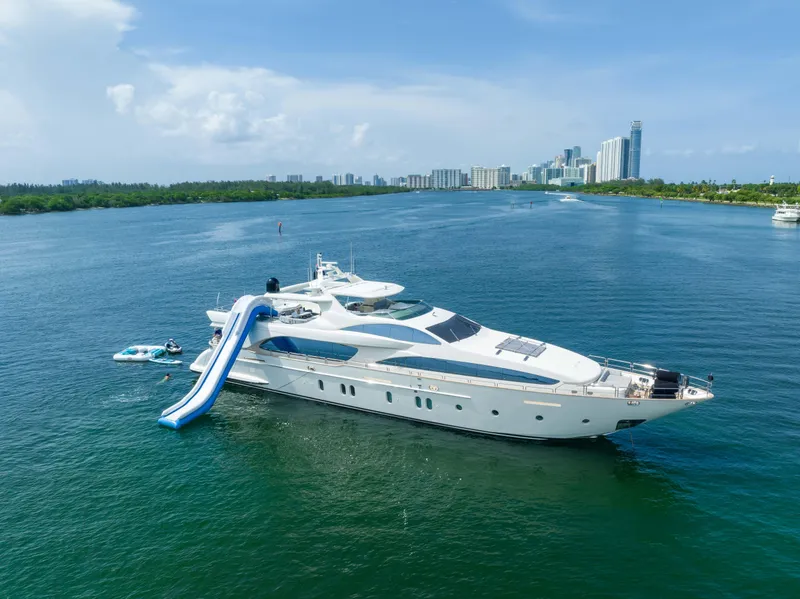 Slide: The Image of Luxury Azimut 116 yacht with slide, 2012 model, cruising in scenic waters near city skyline. - 0