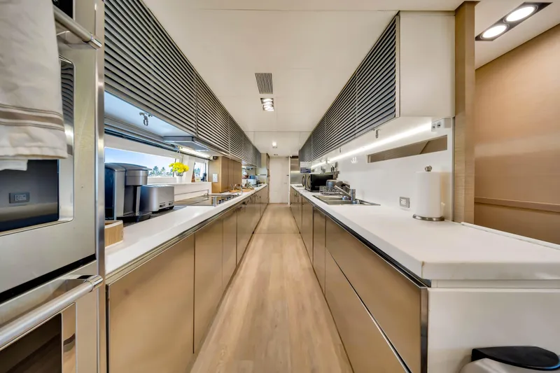 Slide: The Image of Luxurious kitchen interior of a 2012 Azimut 116 yacht, featuring sleek countertops and modern appliances. - 25