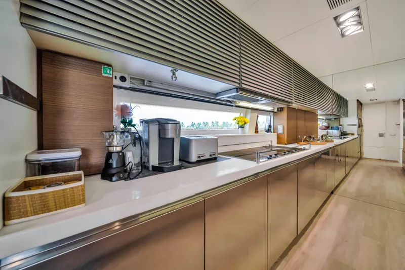 Slide: The Image of Modern kitchen interior on 2012 Azimut 116 yacht, featuring sleek countertops and appliances. - 26