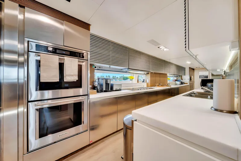 Slide: The Image of Modern kitchen interior on 2012 Azimut 116 yacht, featuring stainless steel appliances and sleek design. - 28